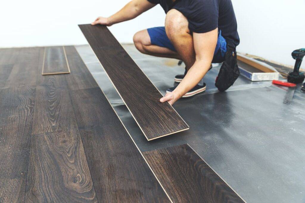 man installing laminate flooring